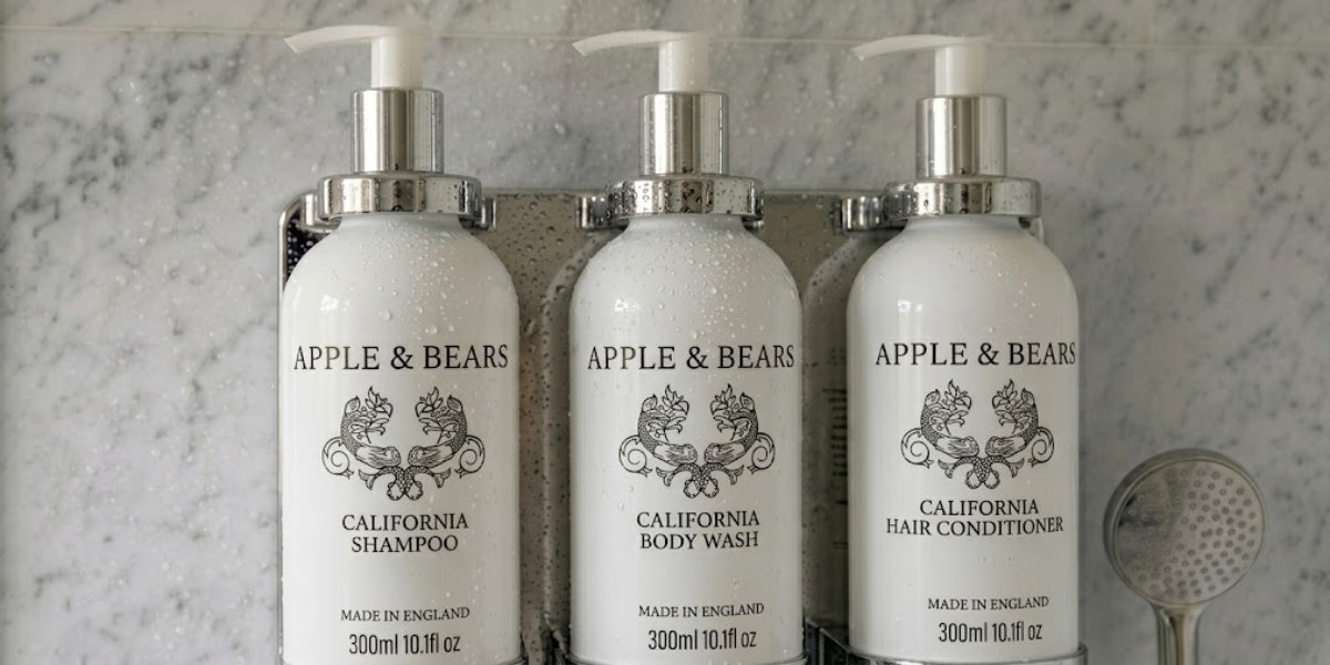 APPLE & BEARS California shampoo, body wash and conditioner dispensers in a hotel bathroom